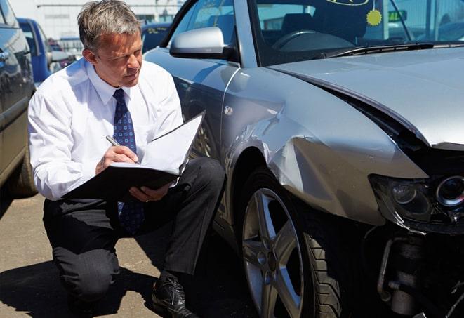 blue car with insurance documents on dashboard